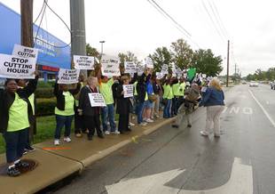 Walmart Associates holding signs on sidewalk